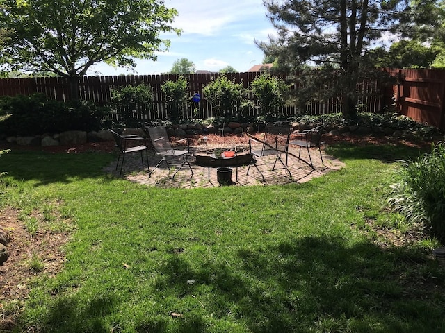 view of yard with a patio, a fire pit, and a fenced backyard