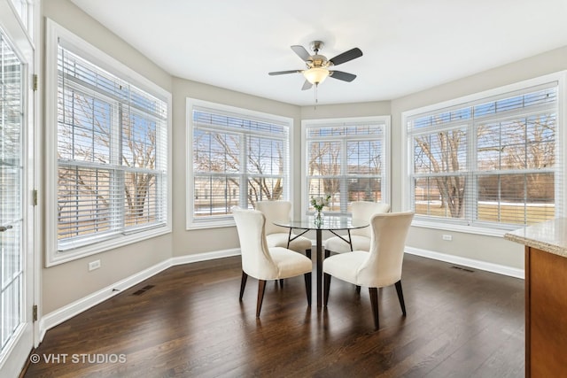 sunroom / solarium featuring a healthy amount of sunlight and ceiling fan