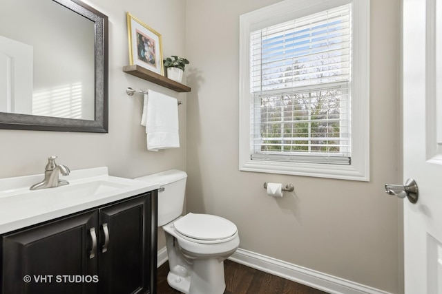 bathroom featuring vanity, hardwood / wood-style floors, and toilet