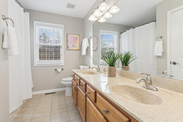 bathroom featuring vanity, tile patterned floors, and toilet