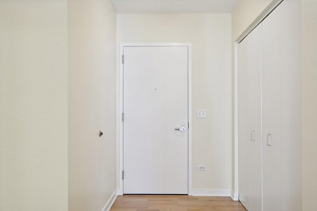 corridor with light wood-type flooring