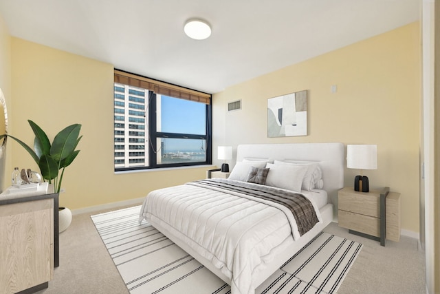 bedroom featuring light colored carpet