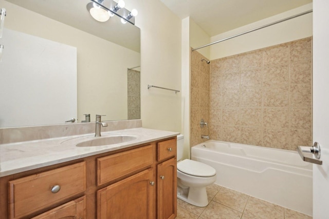 full bathroom featuring tile patterned floors, toilet, tiled shower / bath combo, and vanity