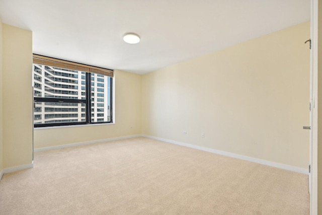 unfurnished room featuring light colored carpet