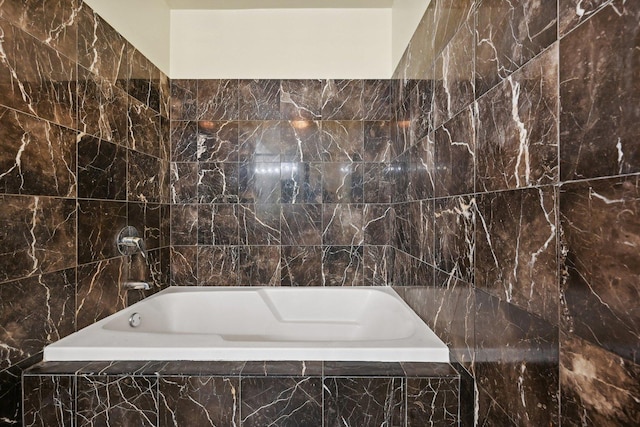 bathroom featuring tiled bath and tile walls