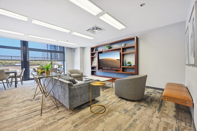 carpeted living room featuring a wall of windows