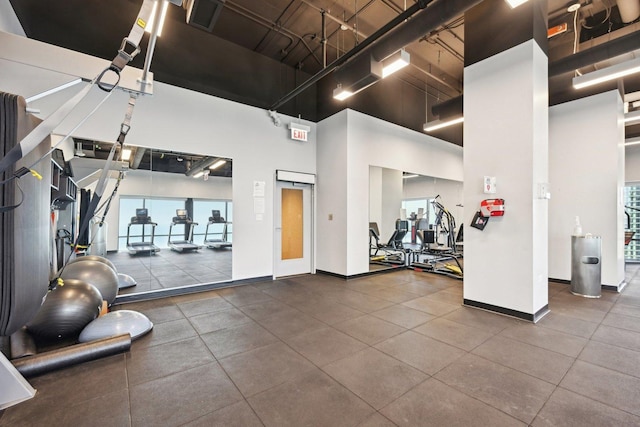 workout area with a towering ceiling