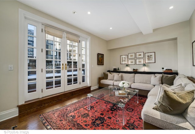 living room with beam ceiling, dark wood-type flooring, and french doors