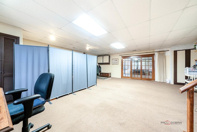 home office with a drop ceiling and carpet floors