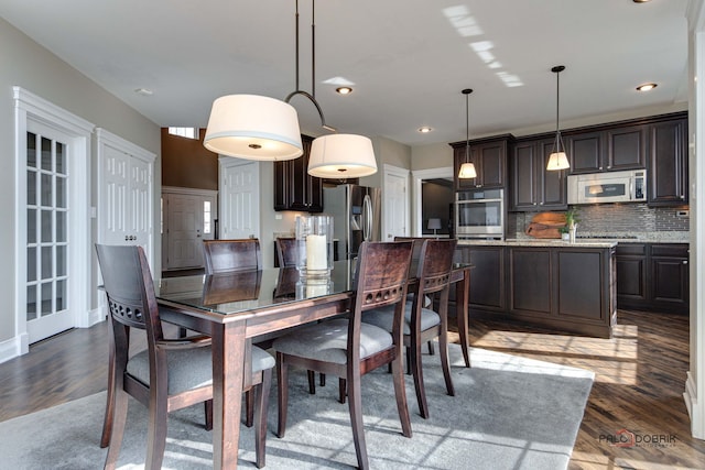 dining area featuring wood finished floors and recessed lighting