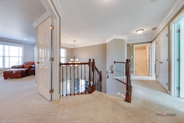 hall with a chandelier, visible vents, an upstairs landing, ornamental molding, and carpet