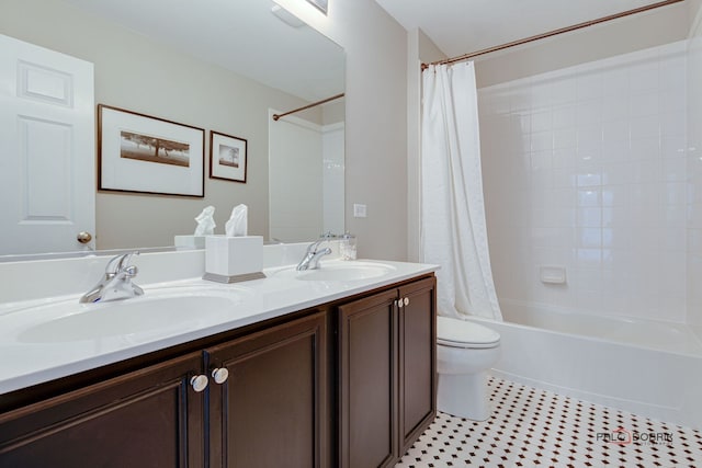 full bath featuring shower / bath combination with curtain, double vanity, a sink, and toilet