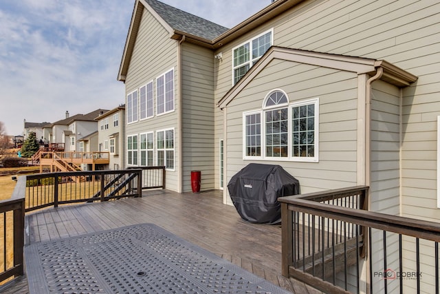 wooden deck with a grill