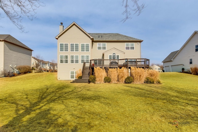 back of house featuring stairway, a lawn, a deck, and a garage