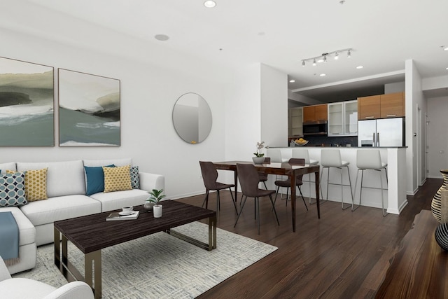 living room with baseboards, wood finished floors, and recessed lighting