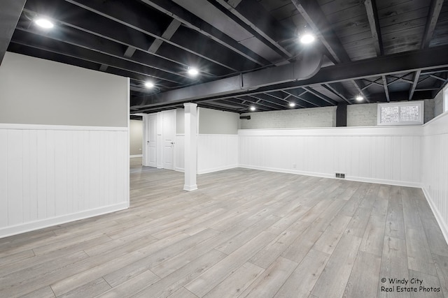 basement with hardwood / wood-style floors