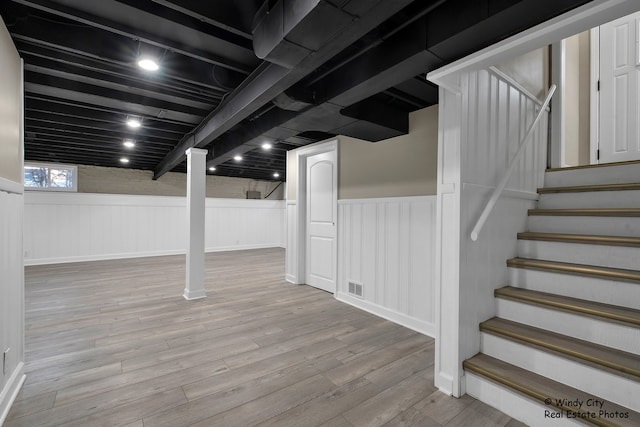 basement with light hardwood / wood-style flooring