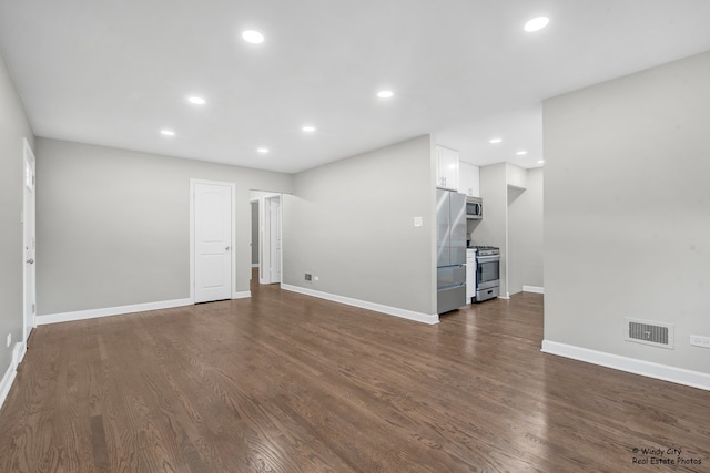 unfurnished living room featuring dark hardwood / wood-style flooring