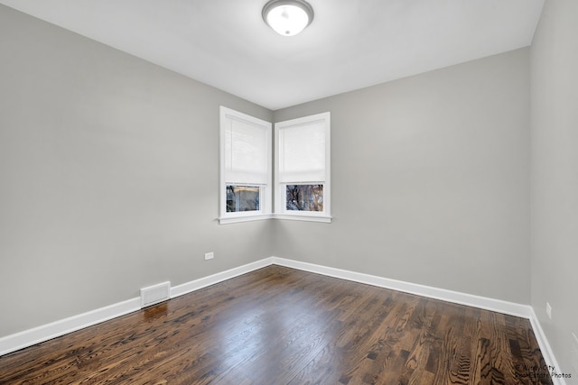 spare room with dark hardwood / wood-style floors