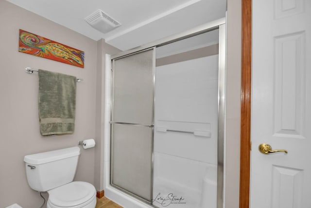 bathroom featuring walk in shower and toilet