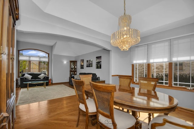 dining room featuring a chandelier and vaulted ceiling