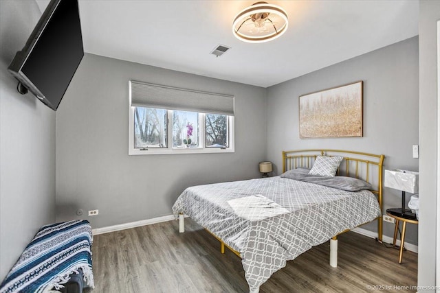 bedroom with hardwood / wood-style floors