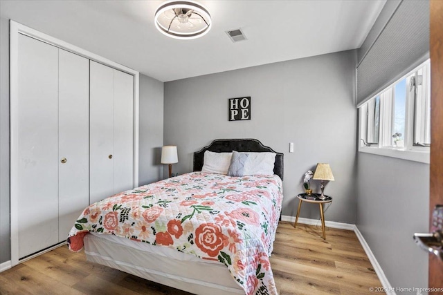 bedroom featuring hardwood / wood-style floors and a closet