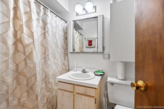 bathroom featuring vanity, toilet, and curtained shower