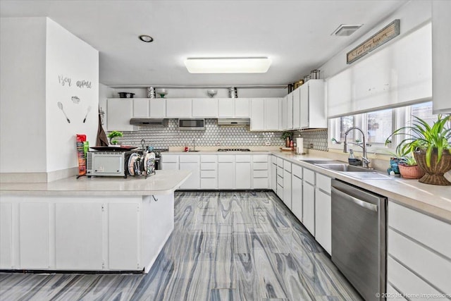 kitchen featuring sink, tasteful backsplash, gas cooktop, dishwasher, and white cabinets