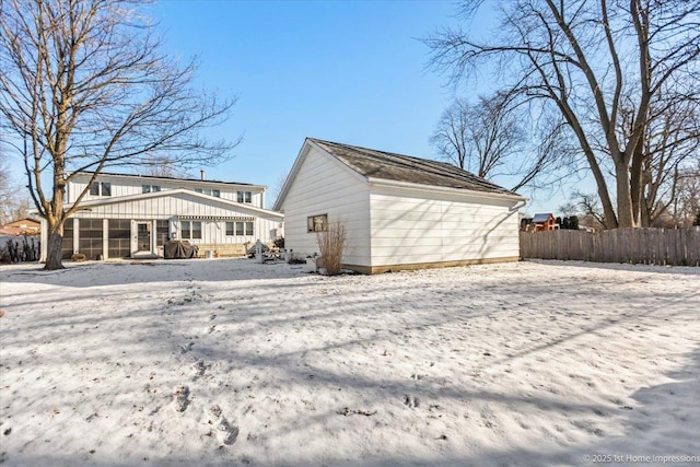 view of snow covered rear of property