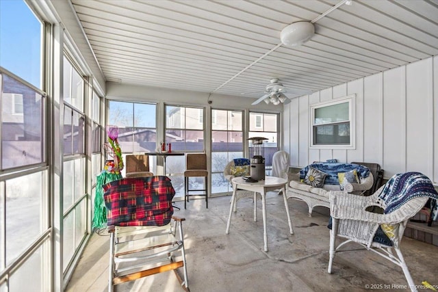 sunroom featuring ceiling fan