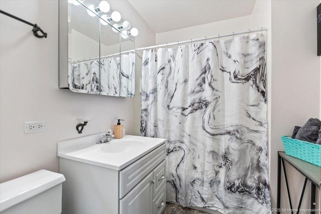 bathroom featuring vanity, a shower with shower curtain, and toilet