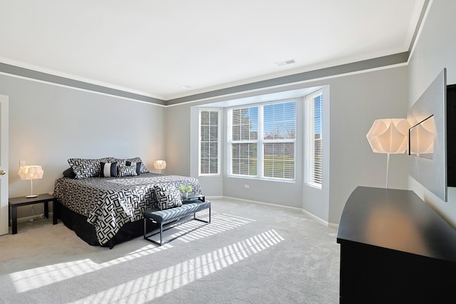 bedroom with light colored carpet and crown molding