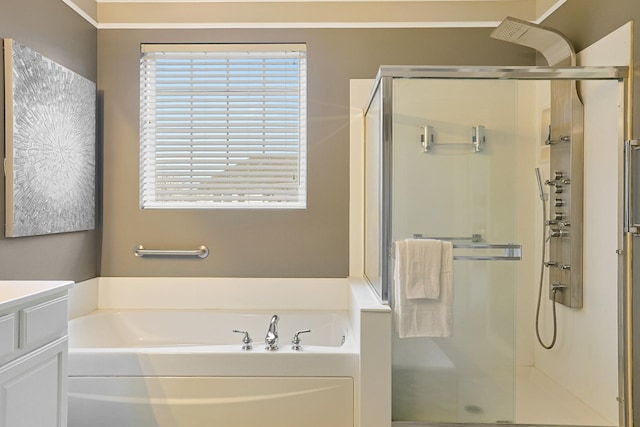 bathroom with shower with separate bathtub, plenty of natural light, and vanity