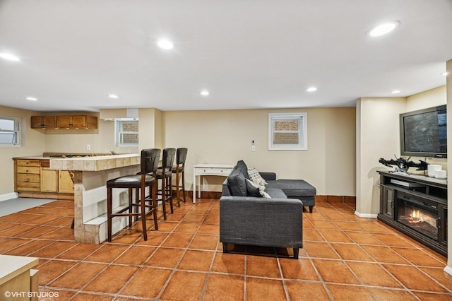 living area with recessed lighting and light tile patterned flooring