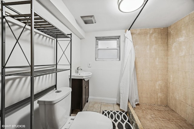 full bath with visible vents, toilet, vanity, tile patterned flooring, and tiled shower