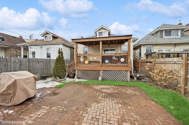 back of house with fence private yard, a patio area, and a wooden deck