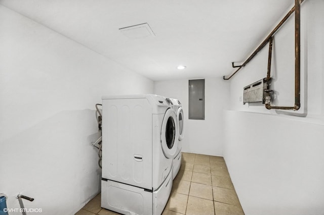 laundry room featuring laundry area, electric panel, separate washer and dryer, and light tile patterned flooring