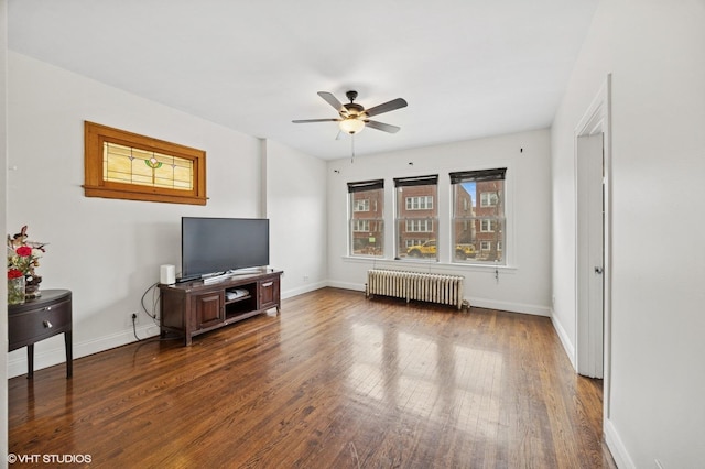 living room featuring ceiling fan, radiator heating unit, hardwood / wood-style flooring, and baseboards