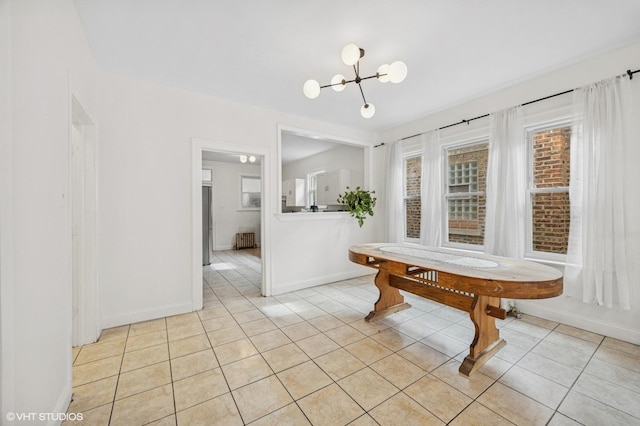 unfurnished dining area with a chandelier, light tile patterned flooring, and baseboards