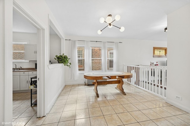 dining space with baseboards and light tile patterned floors