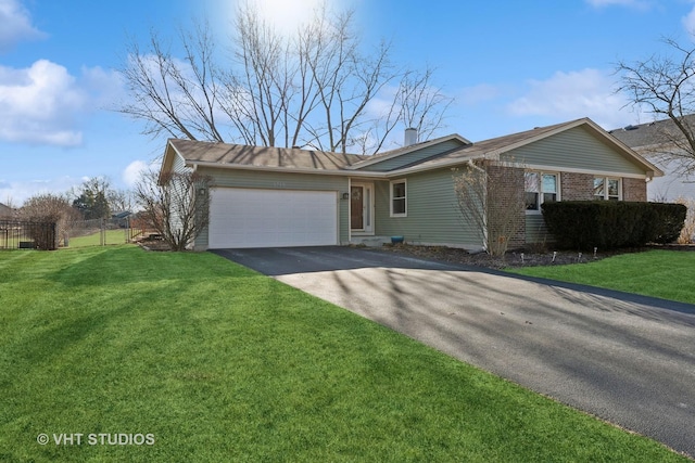 single story home featuring a garage and a front lawn