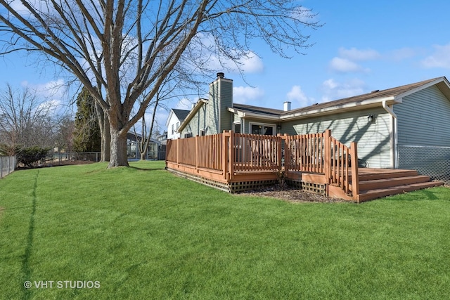 rear view of property with a yard and a deck