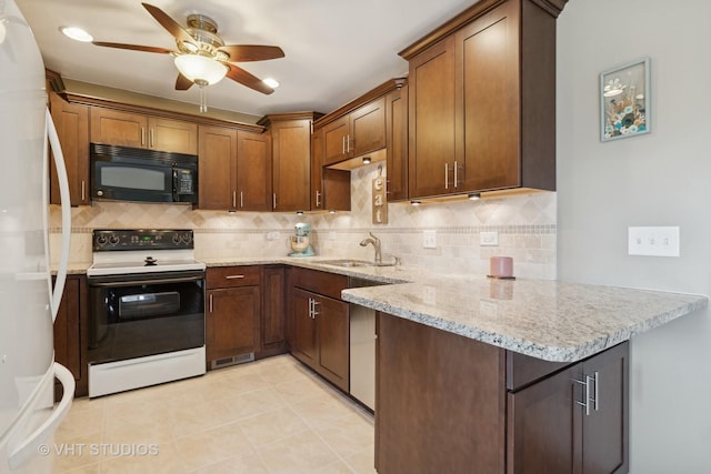 kitchen featuring sink, white appliances, light stone counters, tasteful backsplash, and kitchen peninsula