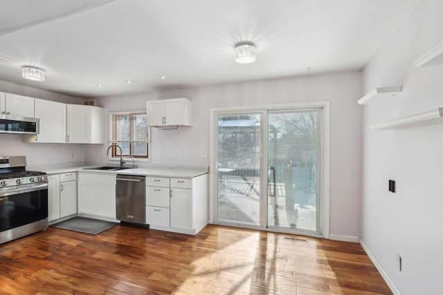 kitchen featuring white cabinetry, sink, and appliances with stainless steel finishes