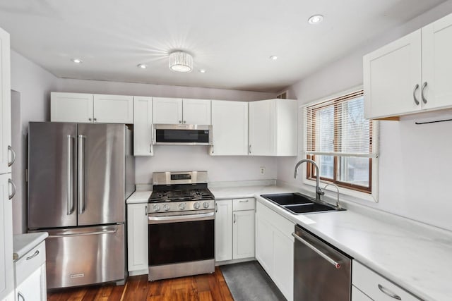 kitchen featuring white cabinetry, stainless steel appliances, dark hardwood / wood-style floors, and sink