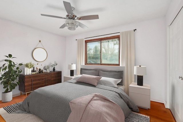 bedroom featuring hardwood / wood-style flooring, a closet, and ceiling fan