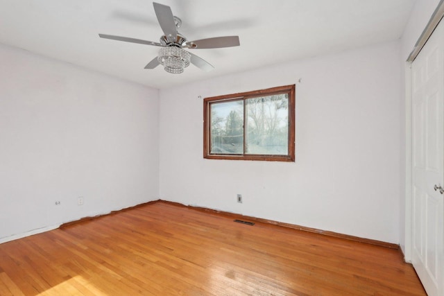 empty room with light hardwood / wood-style flooring and ceiling fan