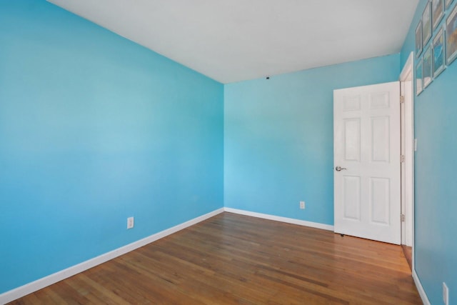 spare room with wood-type flooring