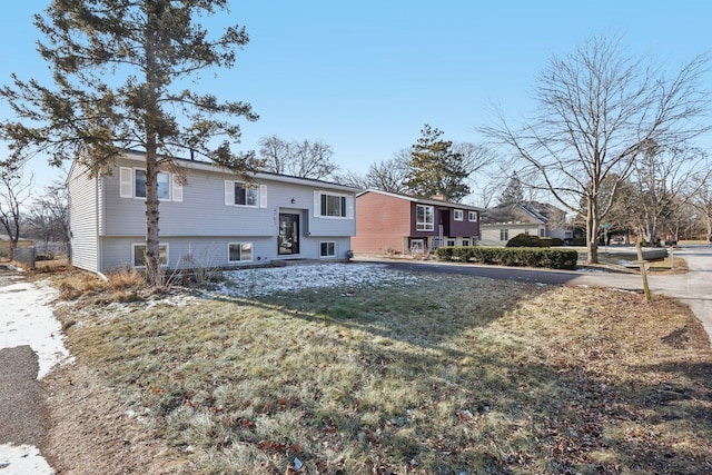 rear view of house featuring a lawn